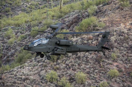 Boeing AH-64E Hovers Low over Desert BI234085
