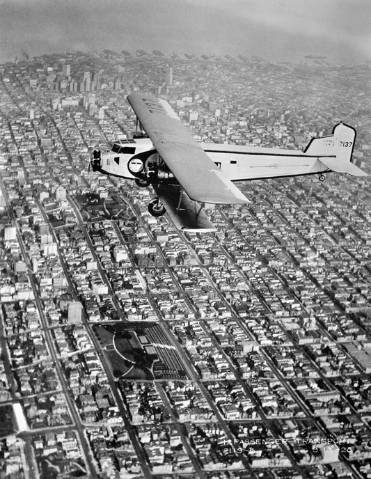 Model 80 in Flight over City BI211836