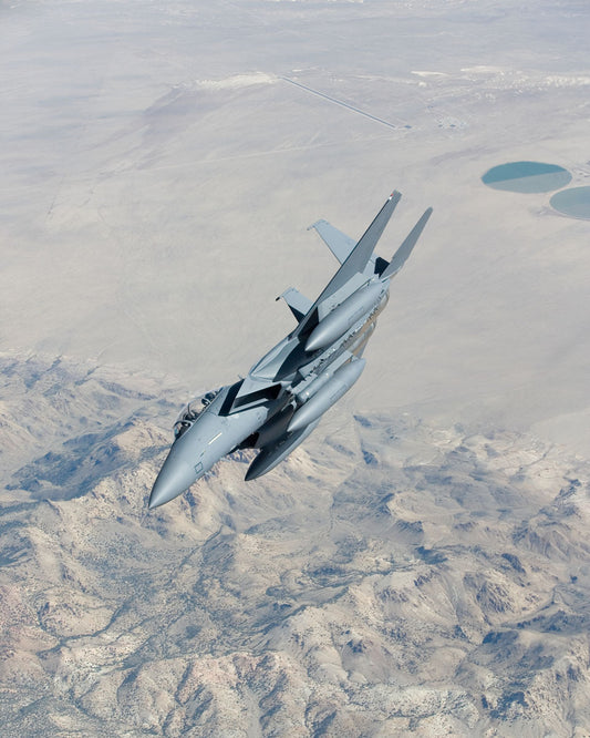 F-15K Strike Fighter Banking in Flight Above Desert BI216596