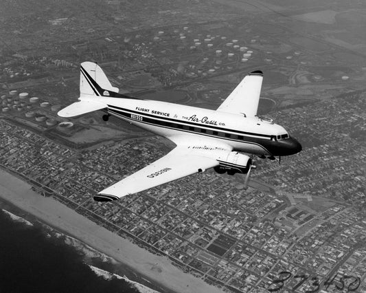 DC-3 in Flight over Suburban Coastline BI217214