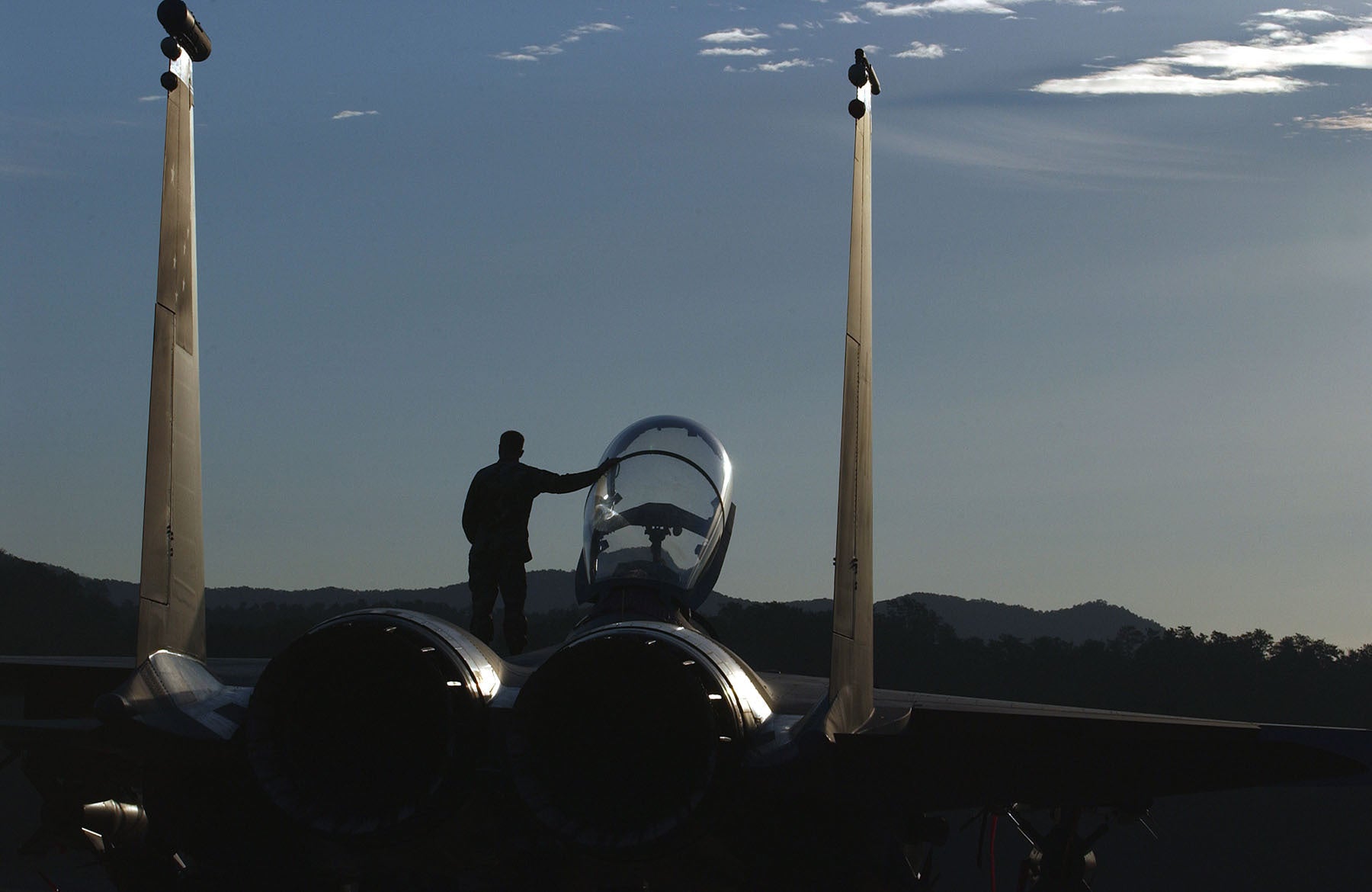 Silhouetted Figure Standing by F-15E Strike Eagle Cockpit BI25474